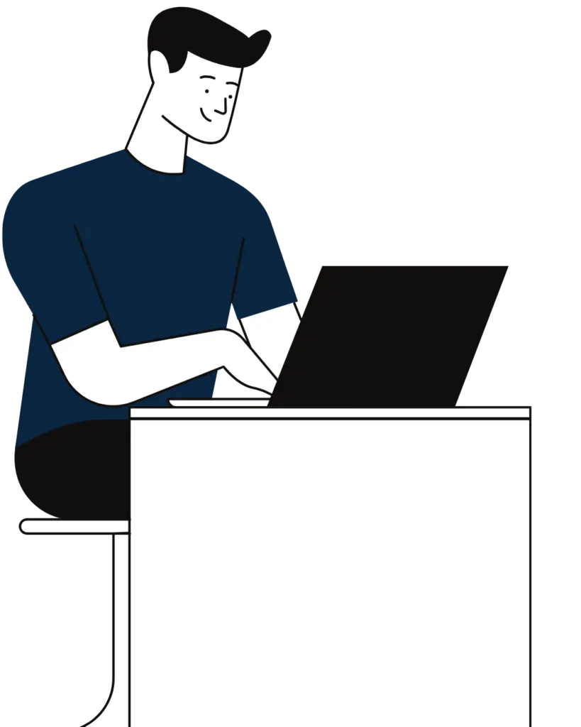 IT professional working on a laptop at a desk